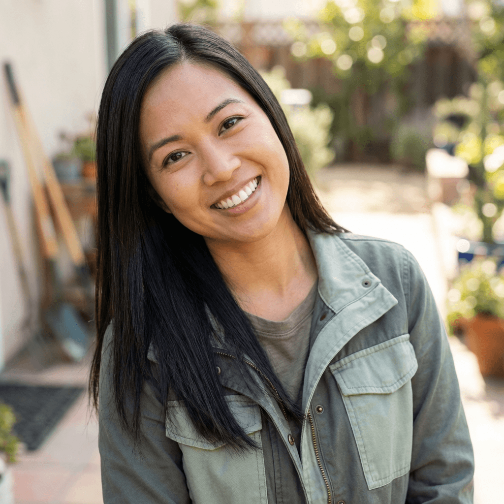 Female homeowner in her late 30s, Hispanic, smiling casually in a bright living room